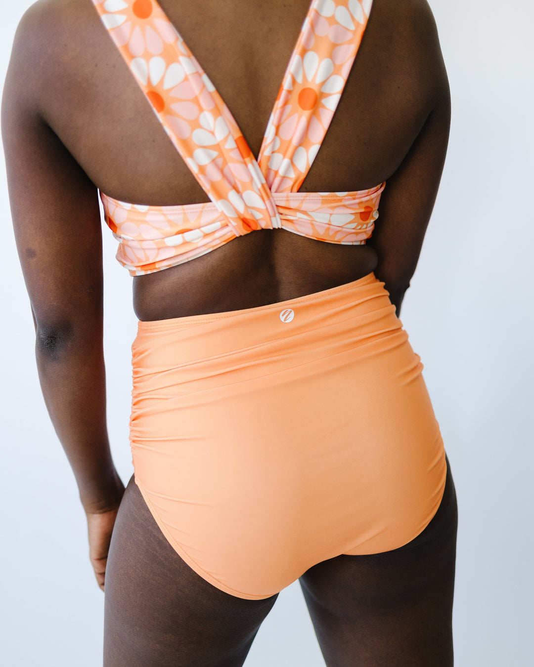 Back view of high waisted orange swimsuit bottoms