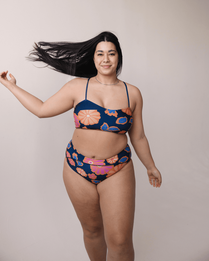 Front view studio image of bold floral patterned swimsuit.